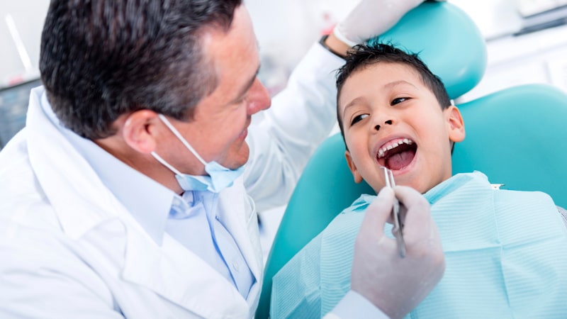 pediatric Dentist - dentist is treating our little patient